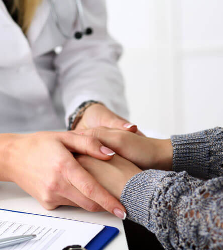 orthopedic doctor holding patient's hand