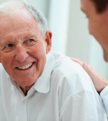 older patient smiling to emg expert