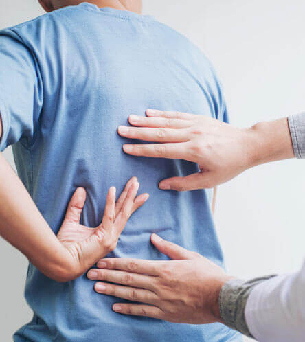 orthopedic doctor examining patient's spine